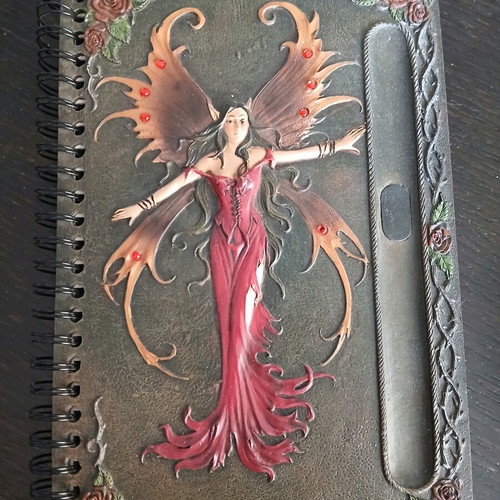 Iron notebook like new with embossed designs and magnet