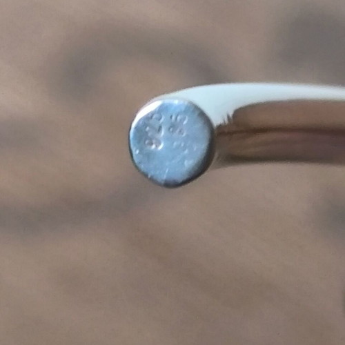 Silver neck rod like new with gold decorative details
