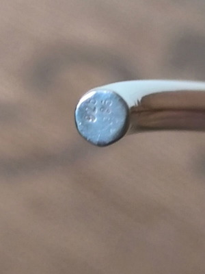 Silver neck rod like new with gold decorative details