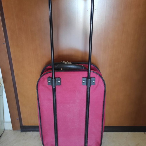 Red fabric travel suitcase trolley carry-on