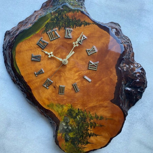 Handmade wooden wall clock from tree trunk.
