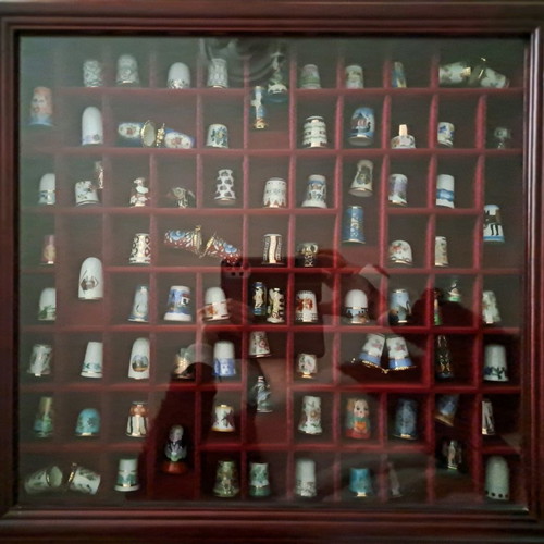 Porcelain thimble collection with wooden display case and book