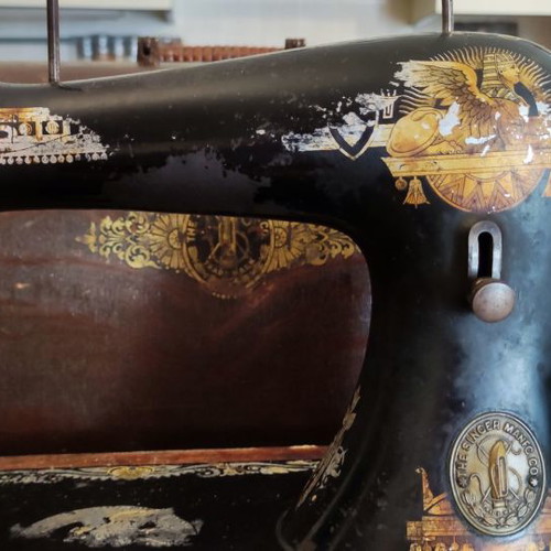 Singer sewing machine used with original wooden cover and key