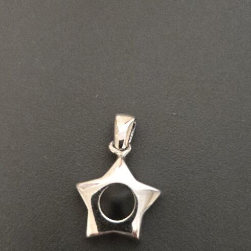 Star-shaped silver pendant with black detail used