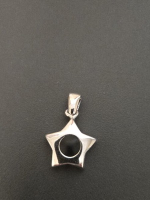 Star-shaped silver pendant with black detail used
