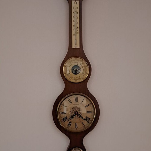Wall clock with barometer and thermometer