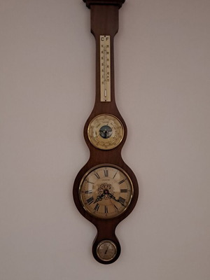 Wall clock with barometer and thermometer