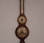 Wall clock with barometer and thermometer
