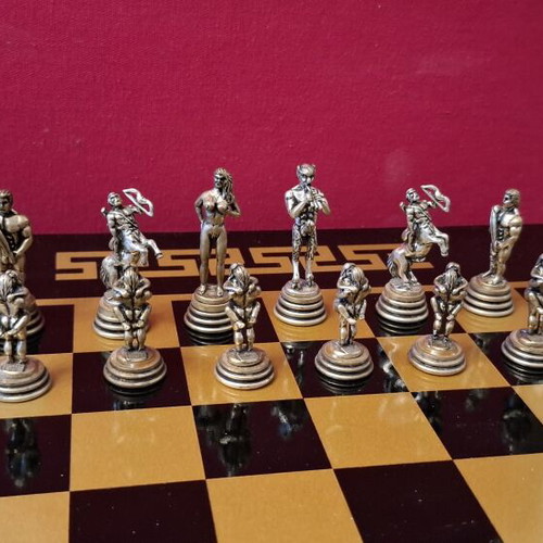 Chess set with decorative metal pieces and black-gold board