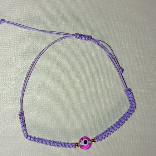 Woven bracelet with eye bead in lilac and fuchsia, new
