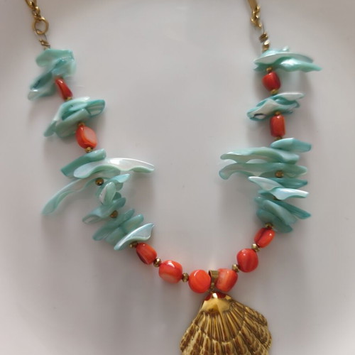 Necklace with shell chips and steel clam pendant
