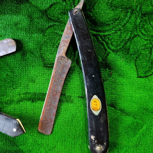 Vintage straight razors with leather strop and wooden handle