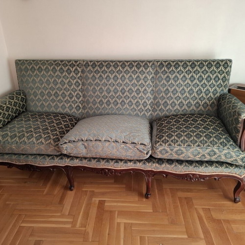 Vintage three-seater sofa and two antique armchairs with dark wood frame