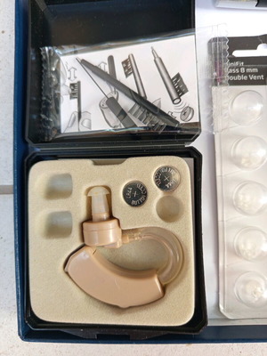 Hearing aids with batteries and cleaning brushes