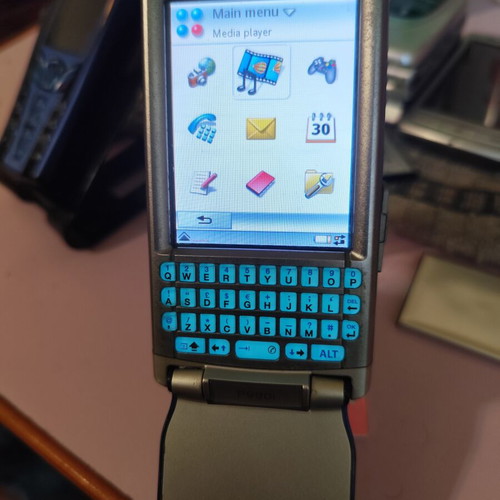 Sony Ericsson P990i vintage cell phone used with charger