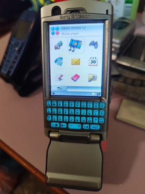 Sony Ericsson P990i vintage cell phone used with charger