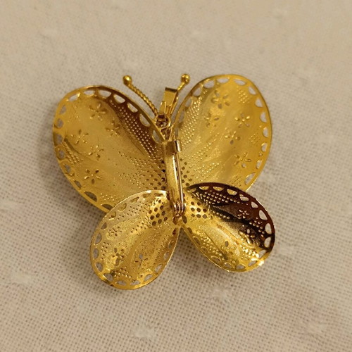 Metal butterfly brooch with rhinestones