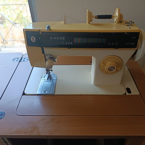 Singer sewing machine with cabinet, used, electric and foot pedal