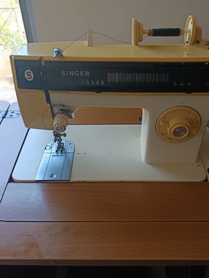 Singer sewing machine with cabinet, used, electric and foot pedal