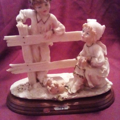 Decorative children with dogs gypsum on wood used