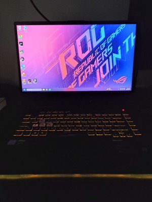 ASUS ROG Strix G531GT gaming laptop with headphones and keyboard
