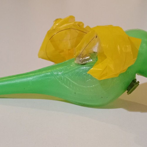 Plastic bird-shaped whistle used, green color