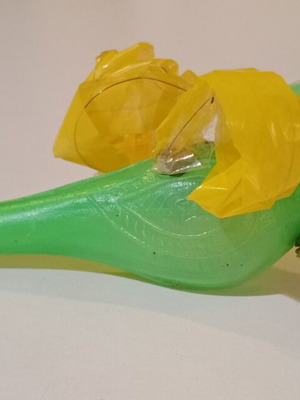 Plastic bird-shaped whistle used, green color
