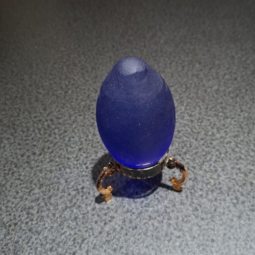 Vintage decorative crystal egg with blue matte glass and gold metal base used
