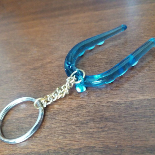 Glass horseshoe keychain used with blue evil eyes