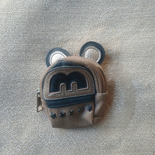 Coin purse used in mini backpack shape with decorative ears and letter M