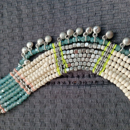 Accessorize multistrand necklace with plastic and glass beads
