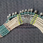 Accessorize multistrand necklace with plastic and glass beads