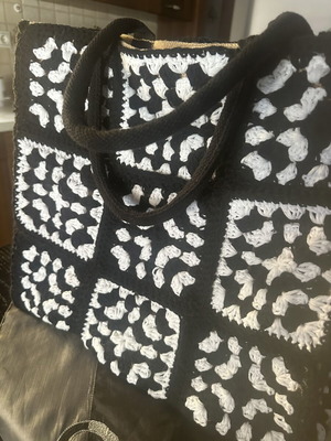 Handmade jute bag with black and white crochet motifs