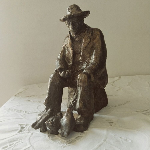 Realistic sculpture of an elderly man feeding pigeons, new