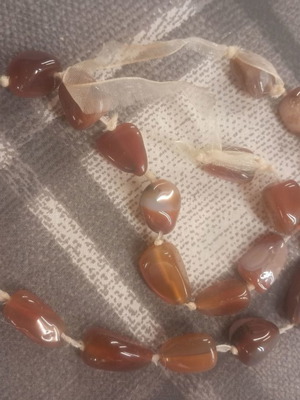 Long necklace with natural polished stones used, brown shades