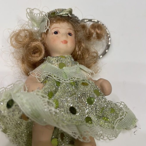 Porcelain doll keychain like new, green, 7cm with movable arms and legs