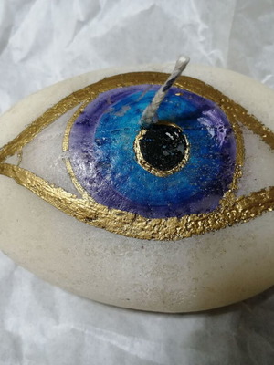 Candle in pebble shape with painted eye new