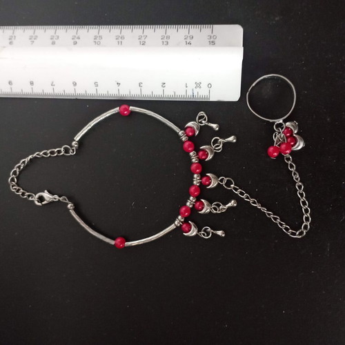 Bracelet with integrated ring with red beads used