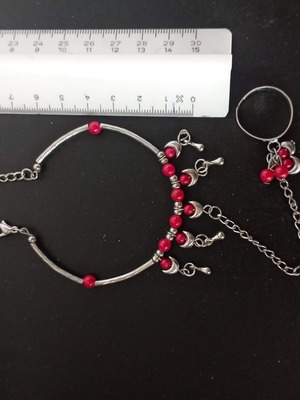 Bracelet with integrated ring with red beads used