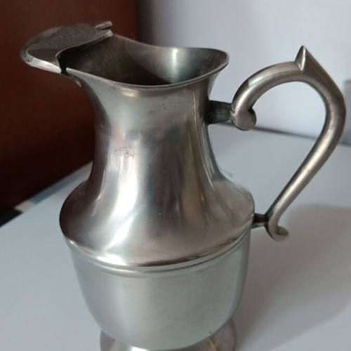 Vintage metal pitcher used with hinged lid and embossed handle