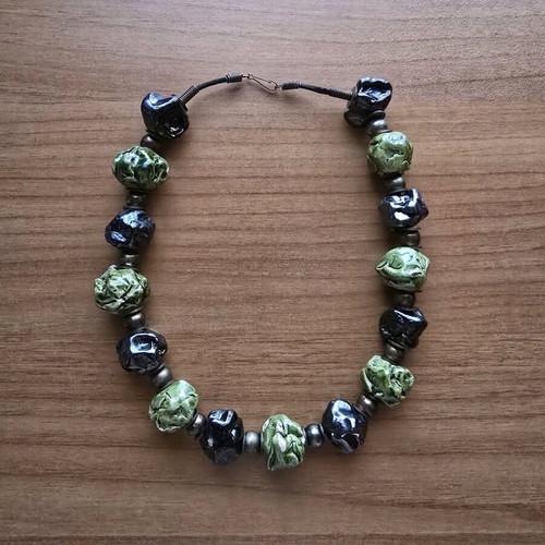 Necklace used with embossed large beads in black and green