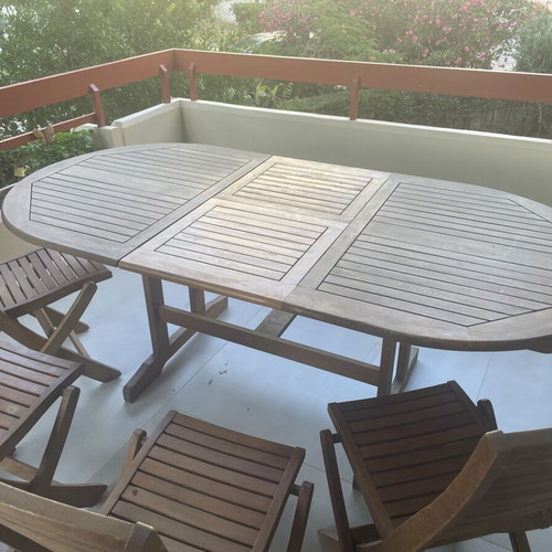 Wooden balcony table with four chairs used