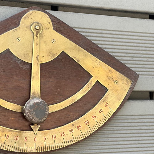 Vintage wooden wall protractor with brass details, used