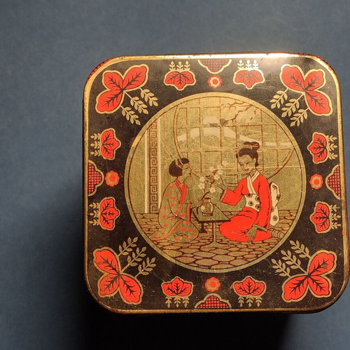 Vintage collectible metal biscuit tin used with Japanese motifs