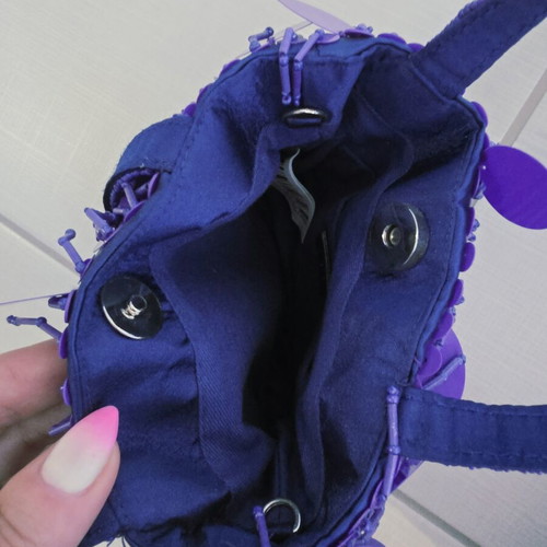 Purple handheld bag with shoulder strap