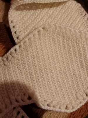 Set of handmade knitted wool pieces used for blanket