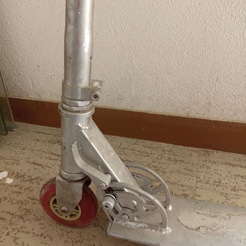Silver metal scooter used, lightweight and foldable