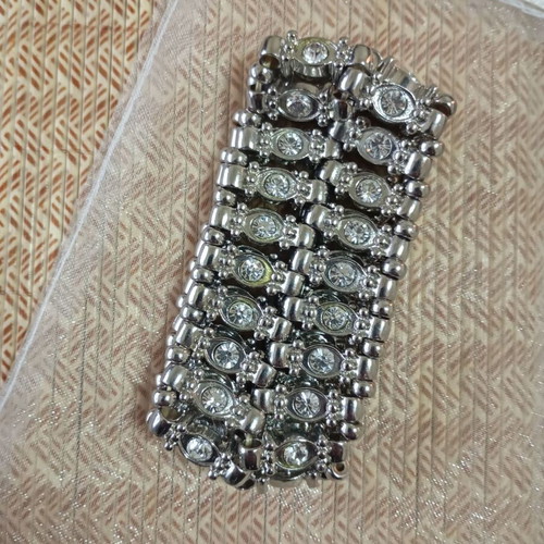 Large bracelet with rhinestones silver like new, elastic band