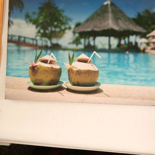 Wooden frame used with tropical pool and coconut motif