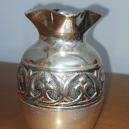 Decorative metal vase used, silver color with embossed design